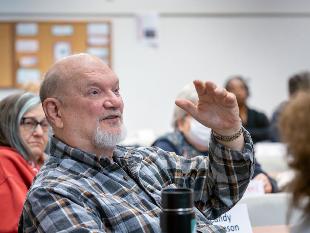 Lifelong learner raises hand during class