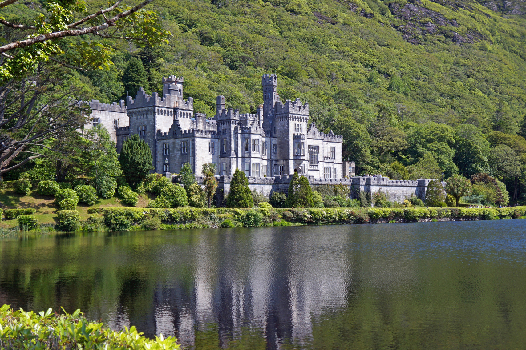 A photo of Kylemore Abbey overlooking a lake  in Connemara, Ireland.