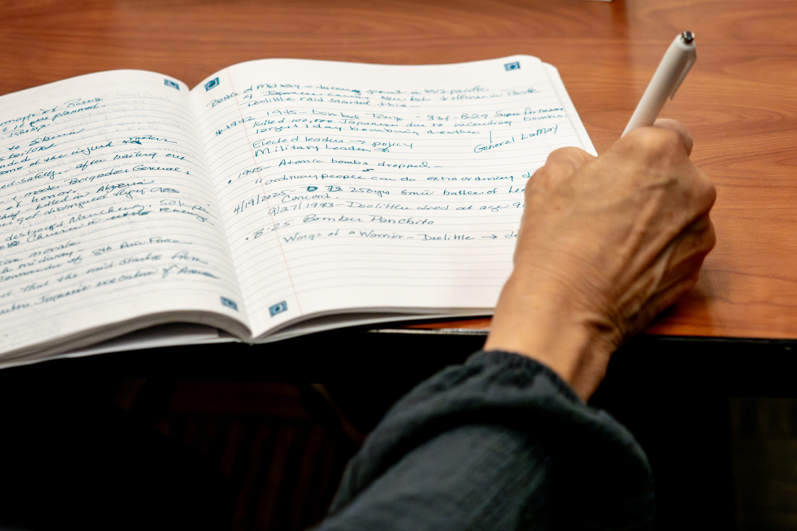 OLLI Member writing notes in the classroom